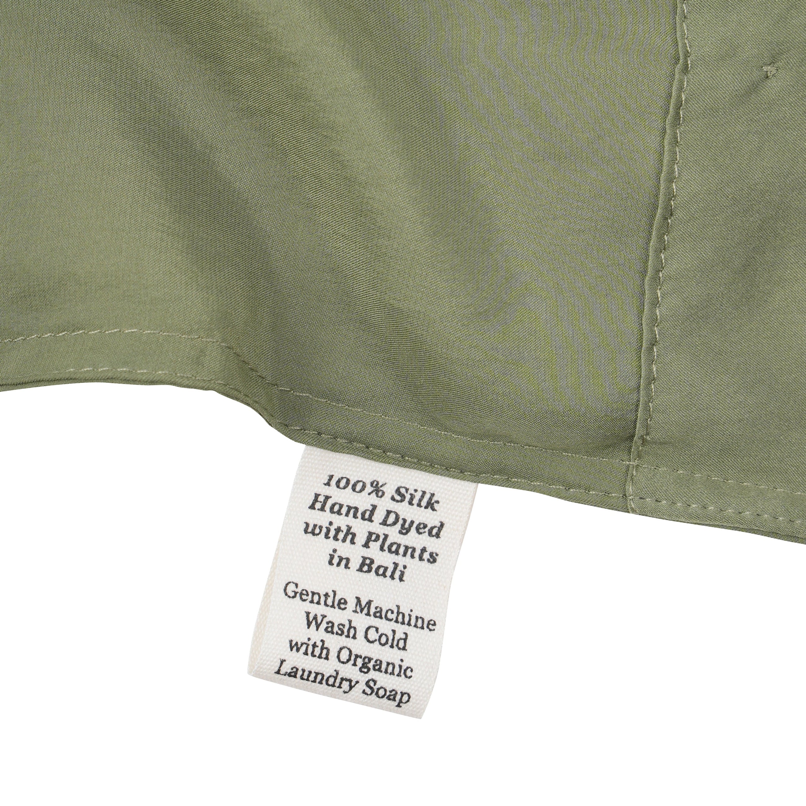 Close-up of a silk in Bark with a label detailing care instructions
