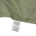 Close-up of a silk in Bark with a label detailing care instructions