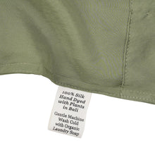 Close-up of a silk in Bark with a label detailing care instructions